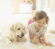 Girl lying in rug with dog